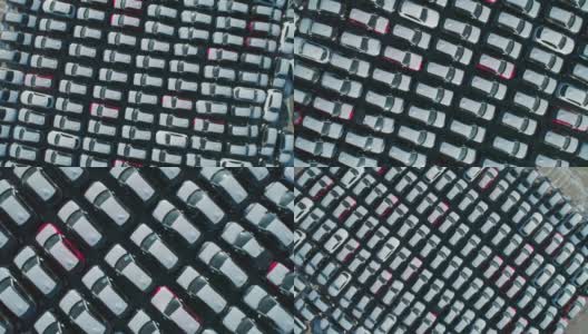 从空中俯瞰的新汽车停在停车场。汽车经销商的停车场满是新车。新车排队等待进出口业务。高清在线视频素材下载