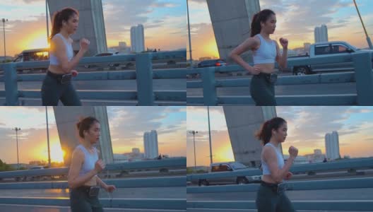 日落，年轻女子慢跑过桥的慢镜头高清在线视频素材下载