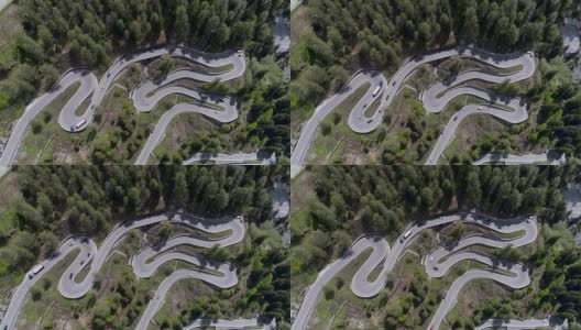 鸟瞰图山上蜿蜒的道路与卡车和汽车行驶在曲折起伏的欧洲瑞士4K高清在线视频素材下载