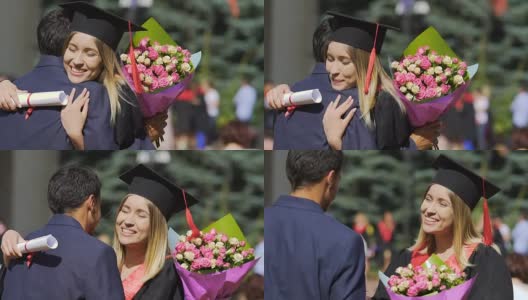 漂亮的女毕业生收到来自男性朋友的鲜花和祝贺高清在线视频素材下载