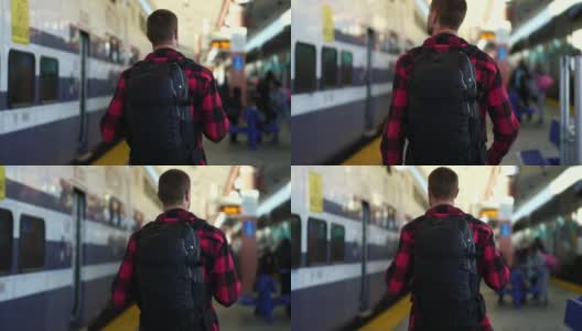 慢镜头:美丽的年轻男子走在洛杉矶火车站的站台上。高清在线视频素材下载
