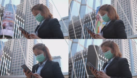 女商人在城市里使用智能手机，慢镜头高清在线视频素材下载