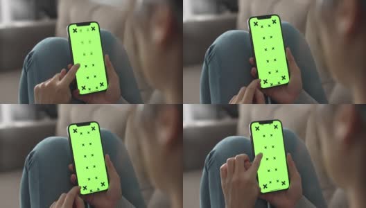女人在用绿色屏幕的智能手机高清在线视频素材下载
