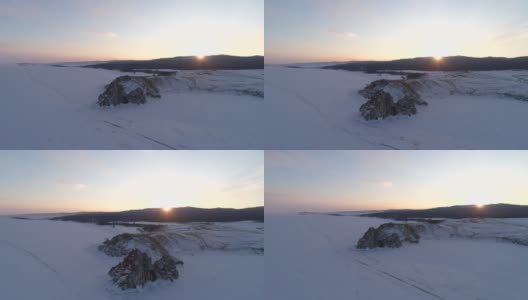 奥尔洪岛上的沙曼卡岩石在日落时的鸟瞰图。冬天的风景。受欢迎的旅游目的地。自然地标。全景高清在线视频素材下载