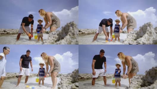 多代同堂的一家人在海滩的水里玩耍高清在线视频素材下载