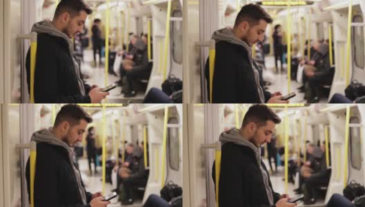 年轻人在地铁里打电话，用智能手机玩游戏，用手机发短信，用手机浏览社交媒体，用一只手玩游戏，戴着耳机听音乐高清在线视频素材下载