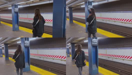 一名戴着防护口罩的妇女走在纽约地铁站台上高清在线视频素材下载