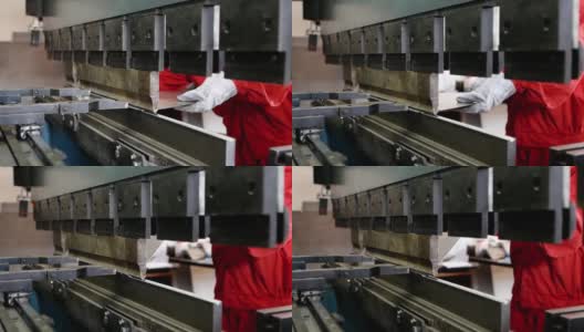 工人用金属加工机器使一块金属弯曲高清在线视频素材下载