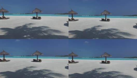 马尔代夫海滩上的帕拉帕和日光浴床高清在线视频素材下载