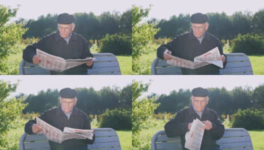 戴眼镜的老人坐在公园的长椅上看报纸高清在线视频素材下载