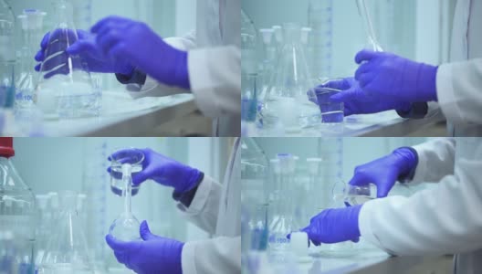 在spbd制药公司，实验室助理正在将液体倒入烧瓶中高清在线视频素材下载