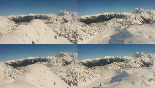 壮观的直升机空中飞行4k镜头飞过桌面山顶滑雪者走向贝克滑雪区舒克山极端高速肾上腺素高清在线视频素材下载
