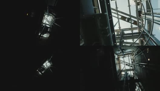 电梯在竖井里往下开。在塔顶，你可以看到电梯的机械装置、缆绳和蓝天高清在线视频素材下载