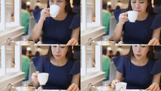 女人一边工作一边喝茶高清在线视频素材下载
