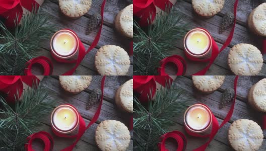 特写燃烧的白色蜡烛和圣诞肉馅饼在质朴的木头桌子上。概念的冬季假期和圣诞烘焙。前视图。高清在线视频素材下载