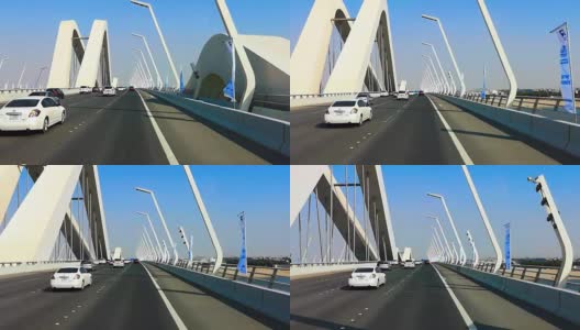 在阿拉伯联合酋长国阿布扎比市的一座现代桥上开车高清在线视频素材下载
