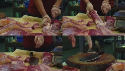 摊贩用刀在木板上切猪肉片的慢动作。高清在线视频素材下载
