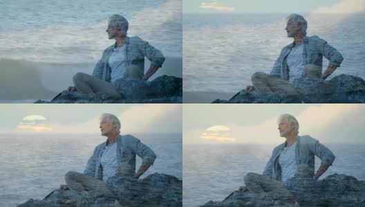 老人坐在岩石上，望着大海高清在线视频素材下载