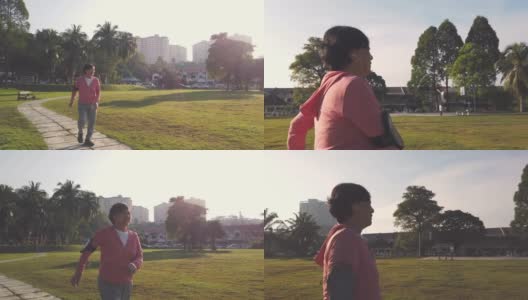 一位华裔老年妇女在公园晨练，在人行道上跑步高清在线视频素材下载