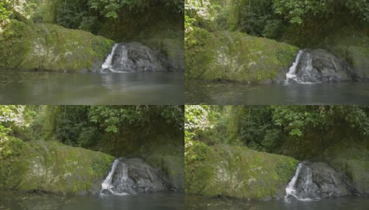 小瀑布流过群山。美丽的淡水在热带雨林的阳光下流入自然池塘。南托克拉曼森林公园。高清在线视频素材下载