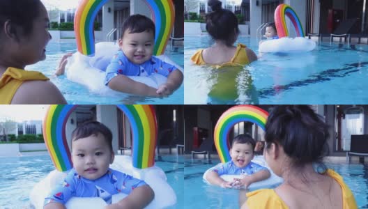 亚洲男婴和妈妈一起在游泳池里学游泳高清在线视频素材下载