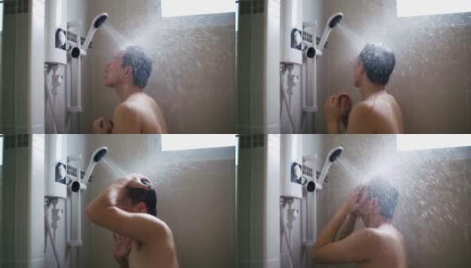 年轻的亚洲男人在浴室里用慢动作洗淋浴。高清在线视频素材下载