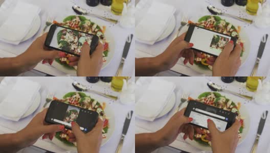 一名女性用4K特写镜头用智能手机拍摄她在餐厅吃健康沙拉的照片，并发布在社交媒体上高清在线视频素材下载