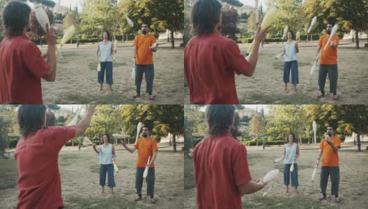 三个年轻的杂耍演员在公园里一起训练高清在线视频素材下载