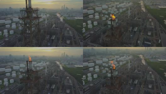 鸟瞰图的化学或炼油厂与燃烧的火炬在城市日出高清在线视频素材下载