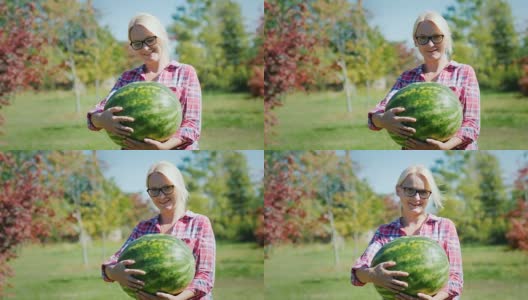 一个女农民拿着一个大西瓜，看着镜头，微笑着高清在线视频素材下载