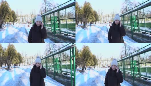 快乐的女孩在电话里聊着城市雪冬天。Slowmotion 120帧/秒高清在线视频素材下载