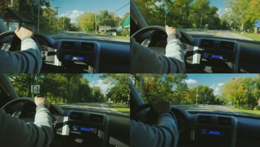 一个男人的手在方向盘上，在一个典型的美国郊区高清在线视频素材下载