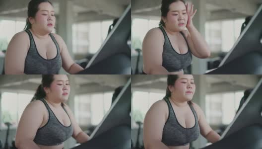超重女性在跑步机上进行有氧运动在健身房里进行锻炼。高清在线视频素材下载