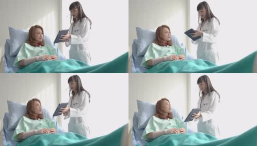 在医院里，坐在轮椅上的病人，专业的医生在为女性折叠的骨折手臂和包扎的手解读x光图像高清在线视频素材下载