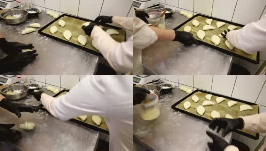 厨师在烹饪店做生面团卷，派和椒盐卷饼高清在线视频素材下载