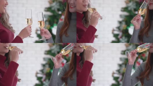 年轻女子在圣诞晚会上祝酒喝香槟。圣诞节的庆祝活动高清在线视频素材下载