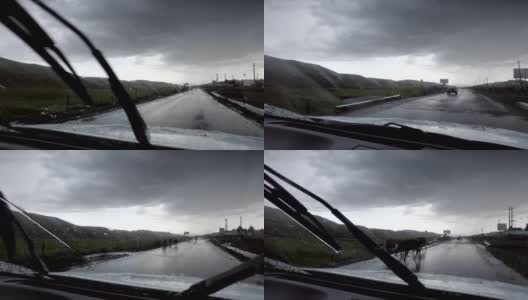 汽车在雨天行驶在山路上，新疆，中国。高清在线视频素材下载