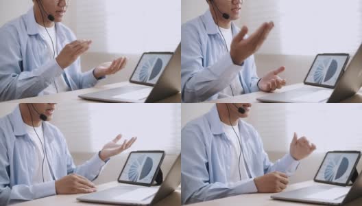 亚洲商人戴上耳机在笔记本电脑上进行视频会议高清在线视频素材下载