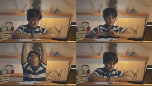 男孩在家里的房间里准备作业和伸展身体高清在线视频素材下载