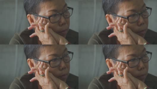 亚洲老年妇女在生活中遭受抑郁。看起来焦虑和不开心。高清在线视频素材下载