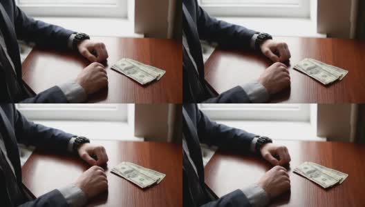 一名西装革履的商人把钞票放在口袋里作为贿赂。贪污贿赂的概念高清在线视频素材下载