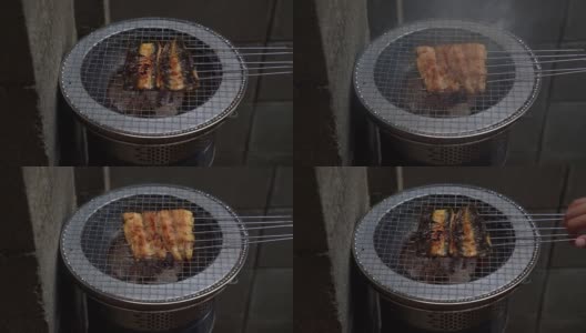 在日本，人们习惯在炎热的夏天吃鳗鱼，并拍下鳗鱼在木炭上烧烤的照片。高清在线视频素材下载