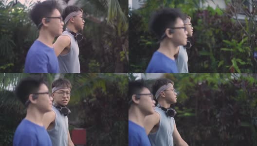 2个亚洲的中国少年在锻炼后互相交流。高清在线视频素材下载