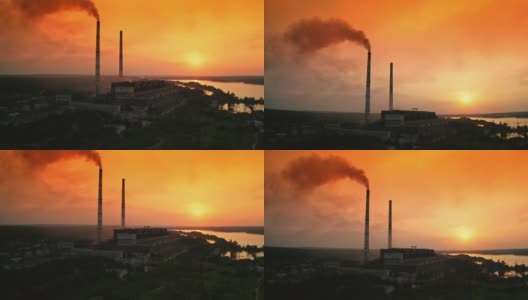工厂里冒着烟的烟囱。日落时工厂烟囱的鸟瞰图高清在线视频素材下载