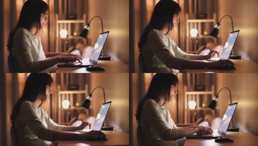 女人晚上在家使用笔记本电脑高清在线视频素材下载