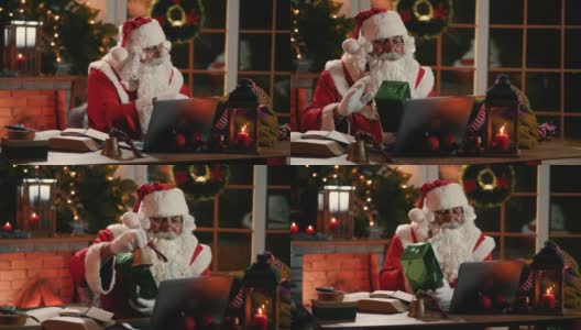 在大流行期间，圣诞老人坐在他的工作间里，向地址发送数据包，与孩子们进行集体视频通话高清在线视频素材下载