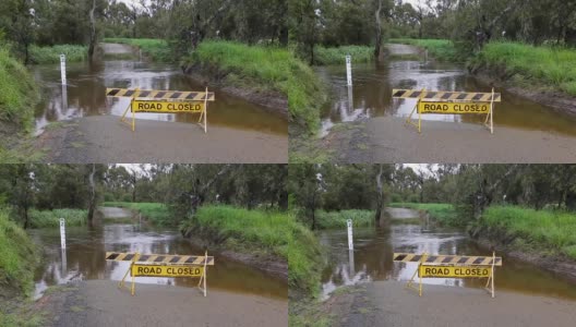 在澳大利亚农村一个被洪水淹没的小溪前，有一个道路关闭的标志高清在线视频素材下载
