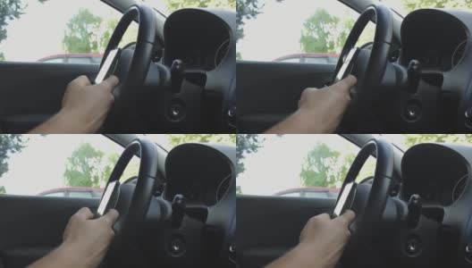 一个男人在车里滚动手机高清在线视频素材下载
