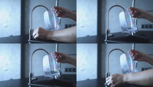 特写的女性手将纯过滤水倒入胶囊咖啡机的塑料容器中。咖啡机补水高清在线视频素材下载