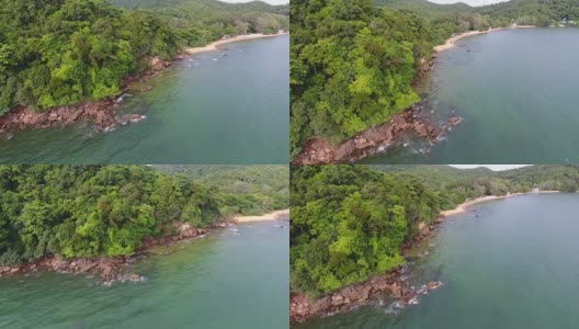 飞越热带海和岩石海滩与波浪破碎，航拍视频高清在线视频素材下载